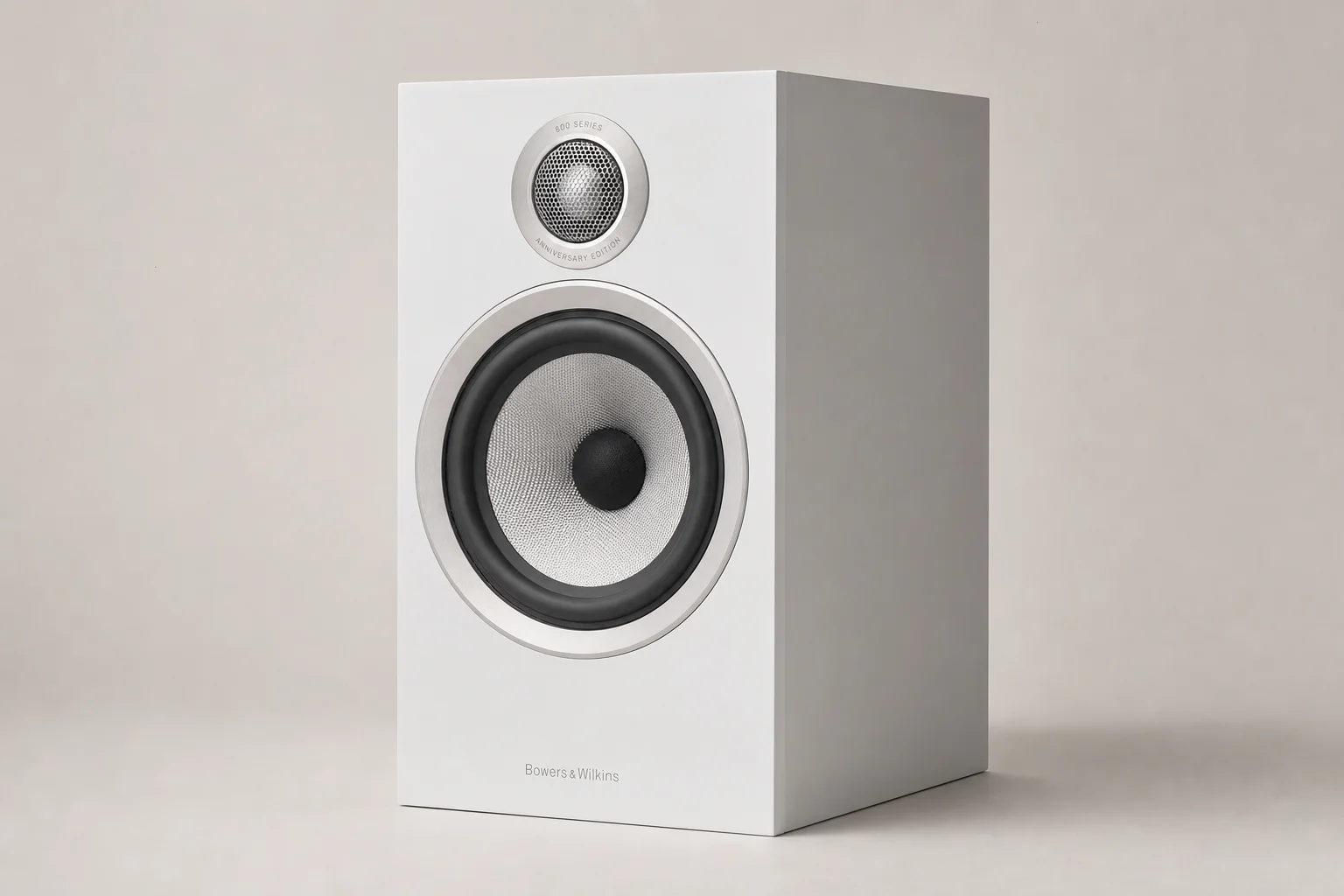 Six bookshelf speakers in various finishes arranged on concrete surface