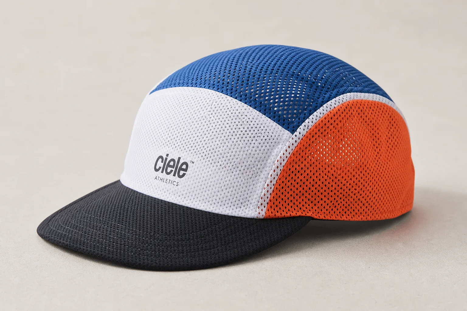 Nine running caps in various styles and colors arranged on neutral backdrop
