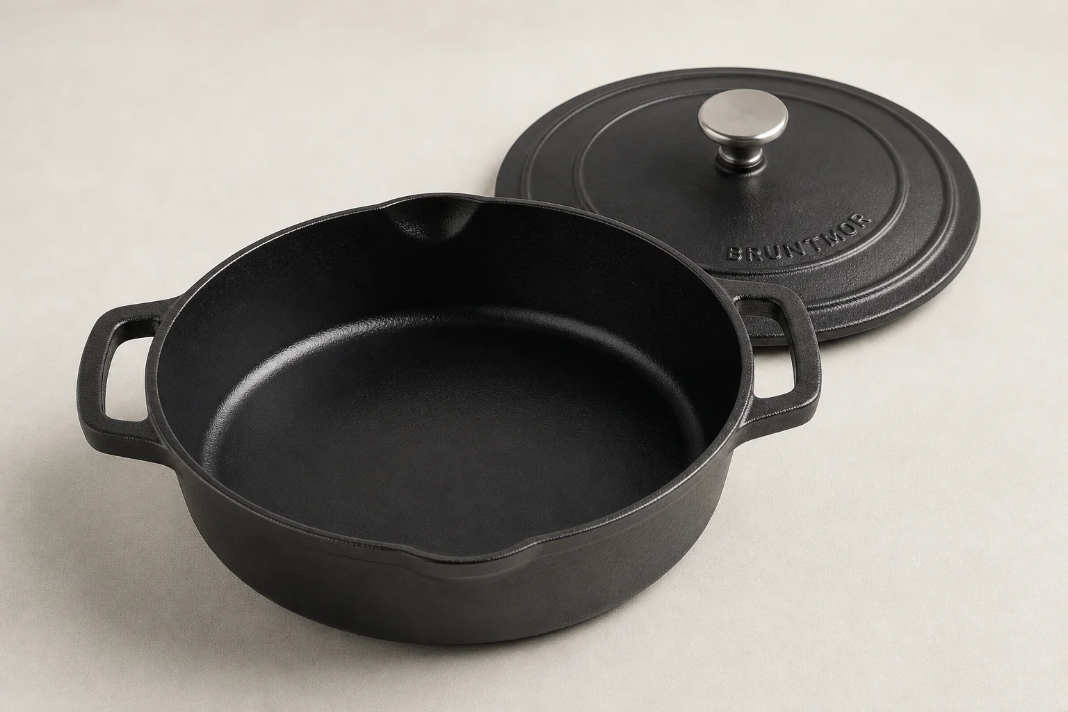 Five cast iron skillets arranged on a wooden surface showing different styles and finishes