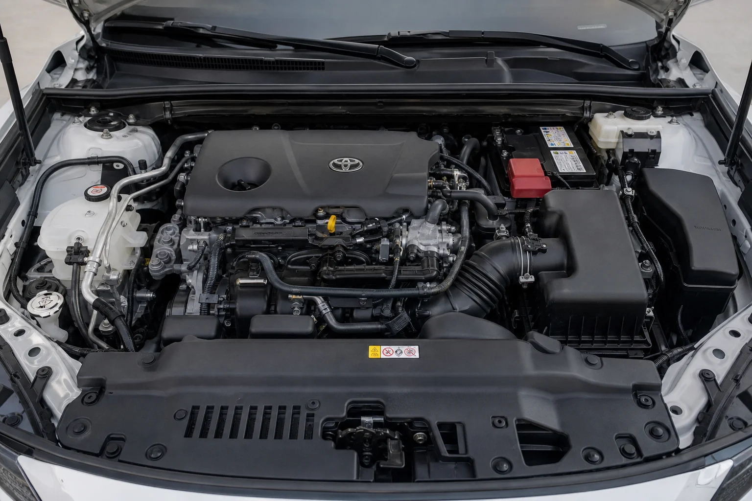 Automotive engine bay interior with complex geometry and varied surface finishes