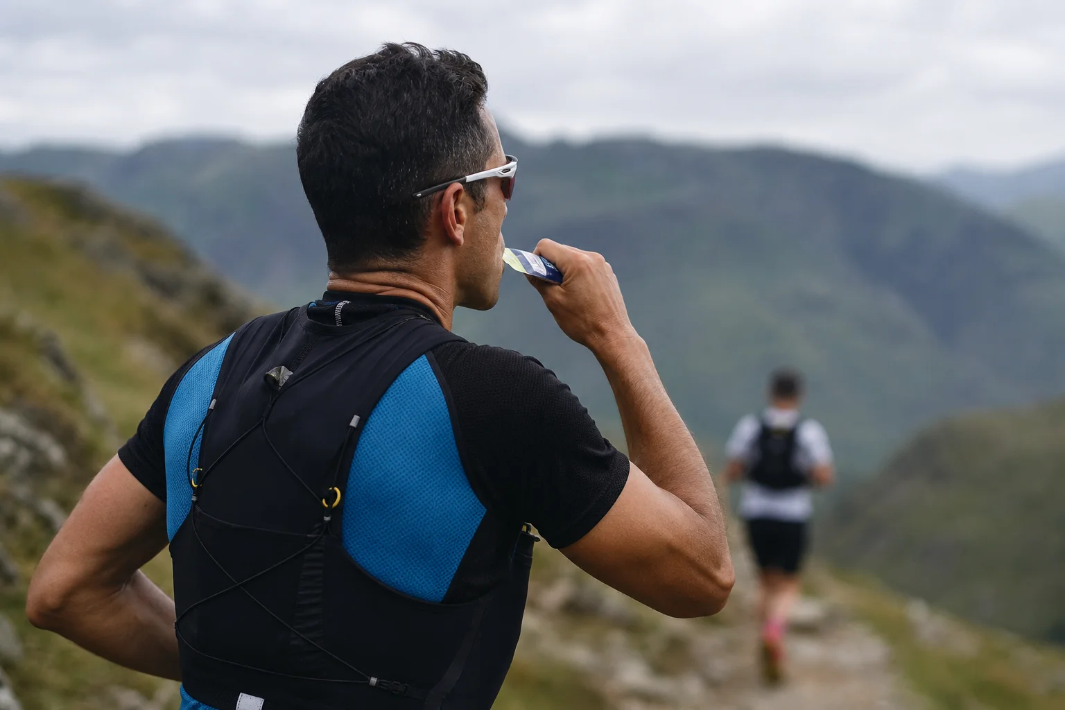Athlete consuming an energy gel during an outdoor endurance event