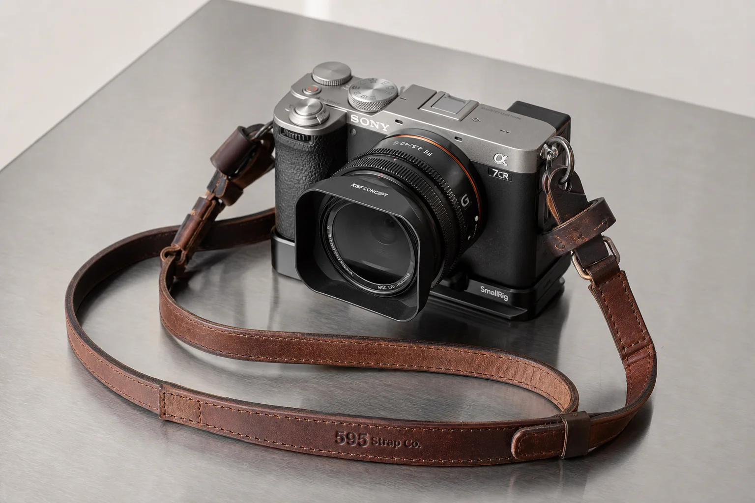 Complete street photography camera setup with Sony A7CR, lens, hood, strap, and accessories on brushed metal surface