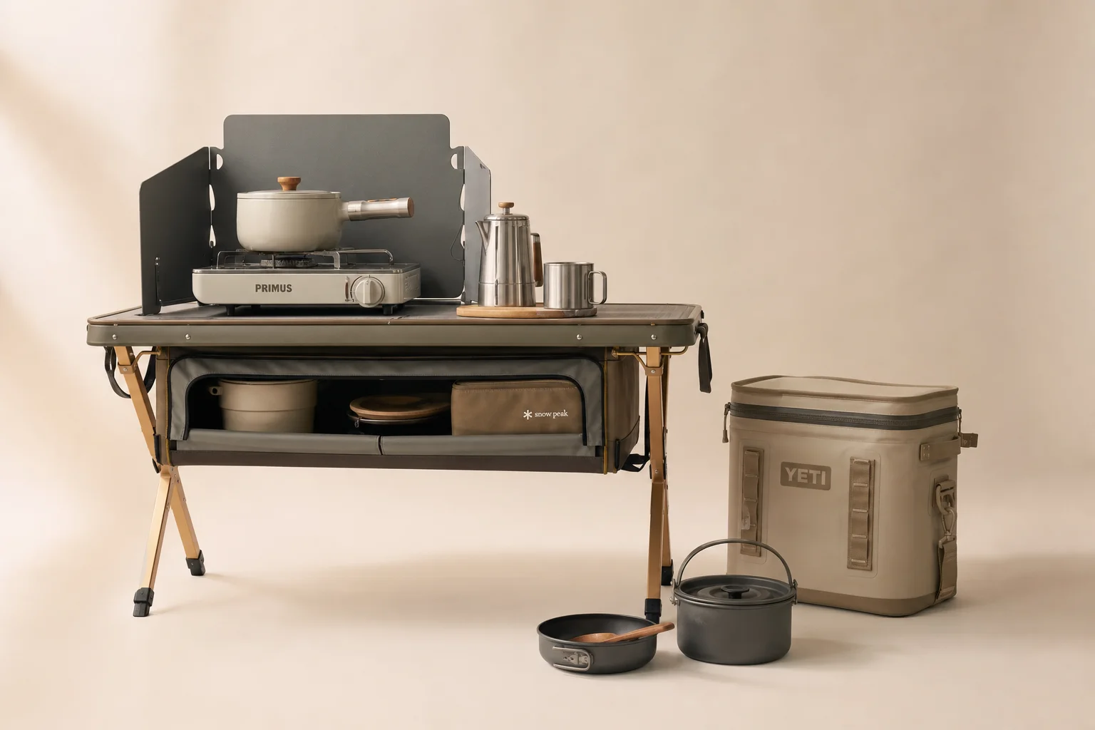 Camping kitchen setup with portable table, cooler, and cooking equipment