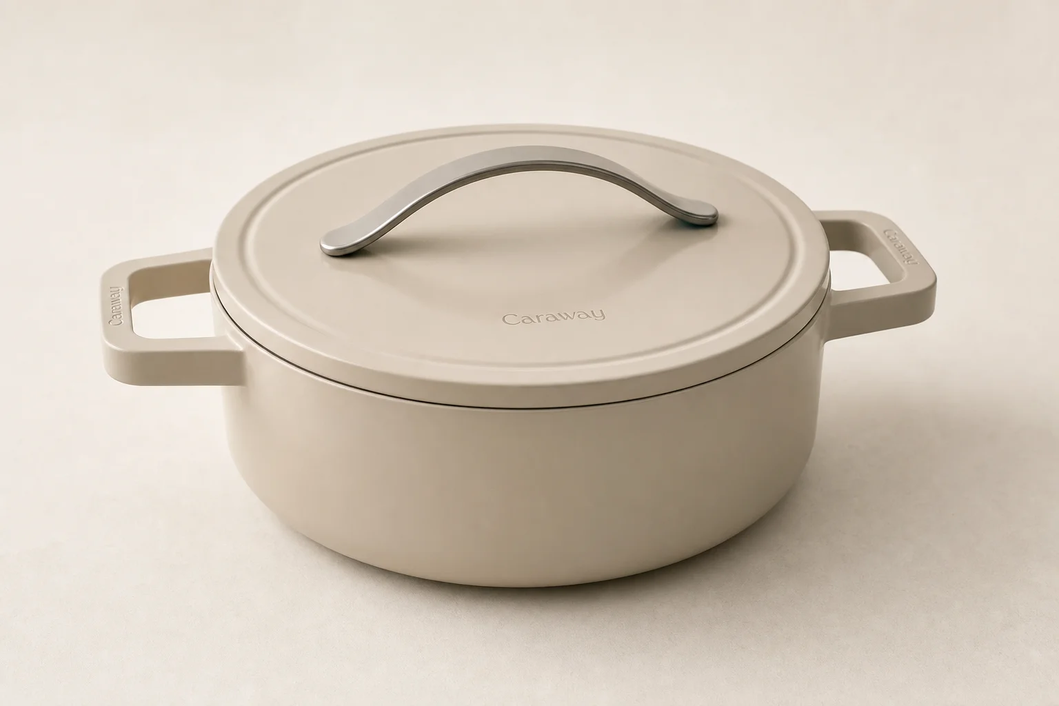 Six Dutch ovens in different sizes arranged on concrete surface