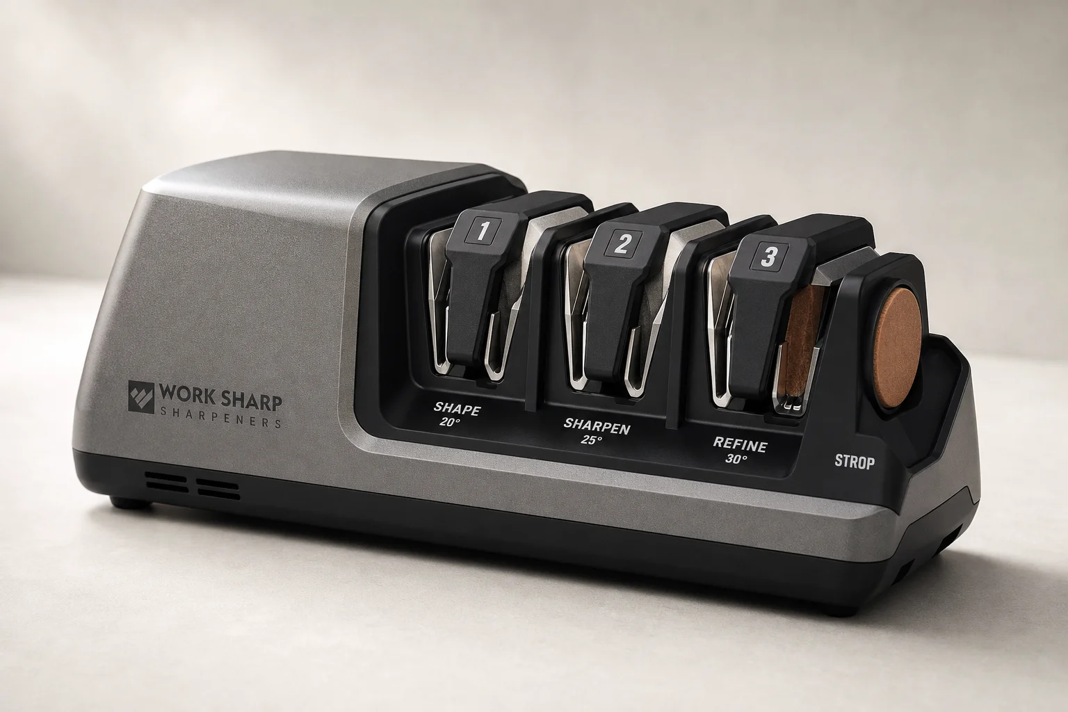 Five knife sharpeners arranged on concrete surface from manual to professional electric models