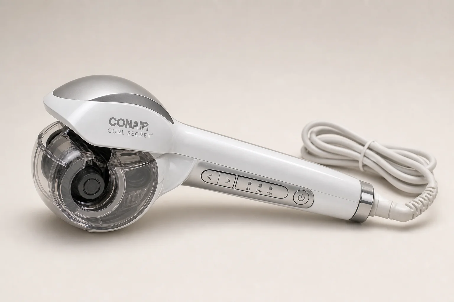 Conair Curl Secret 自動捲髮器放置於中性背景上，透明捲髮室清晰可見