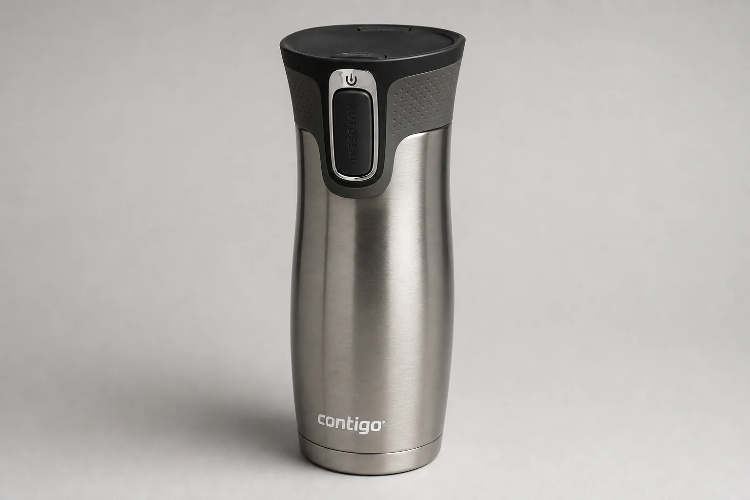 Five travel mugs arranged in ranking order on a concrete surface