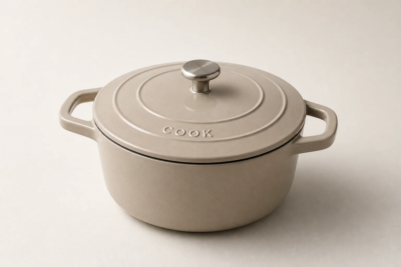 Six Dutch ovens in different sizes arranged on concrete surface