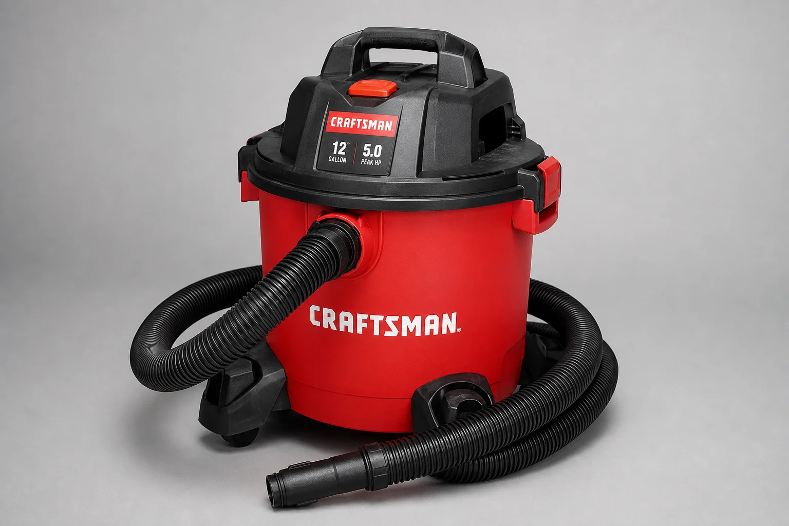 Five shop vacuums of varying sizes arranged on a concrete workshop floor