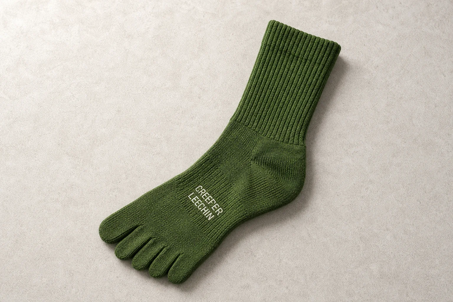 Collection of running socks in various colors and styles arranged on concrete surface