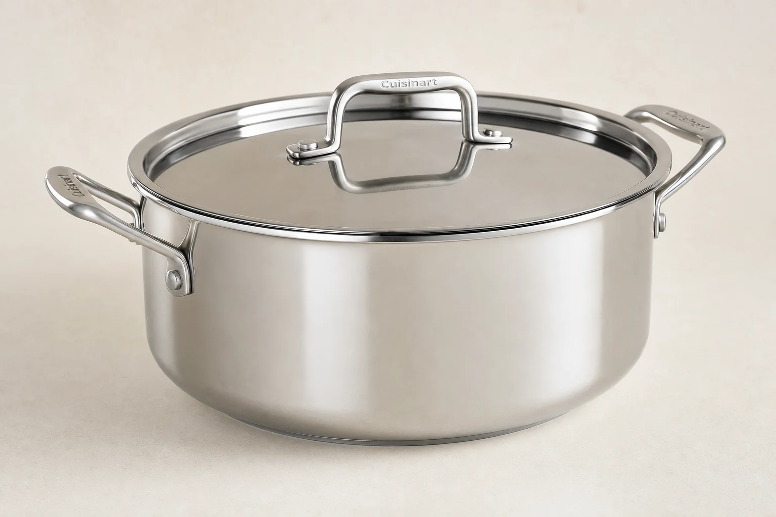 Six Dutch ovens in different sizes arranged on concrete surface
