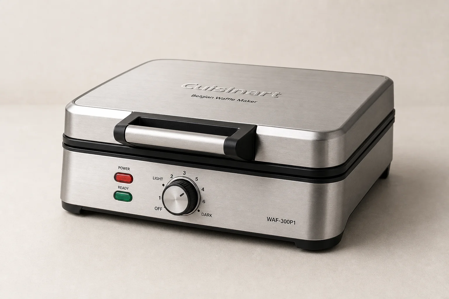 Five waffle makers arranged on concrete surface from budget to premium models