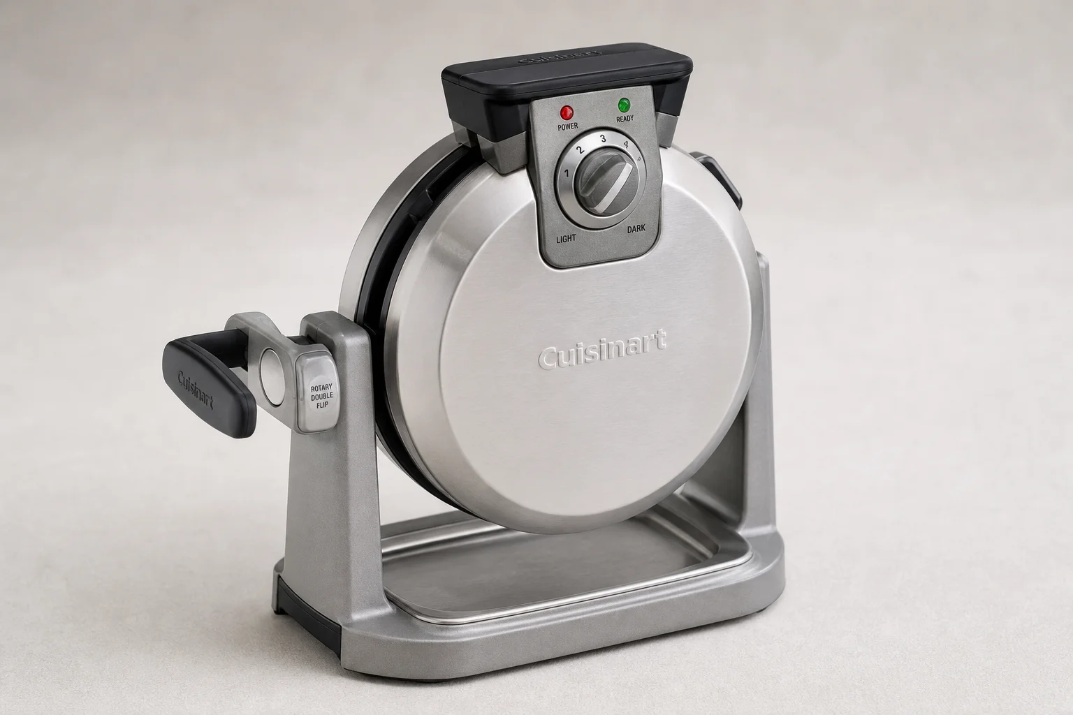 Five waffle makers arranged on concrete surface from budget to premium models