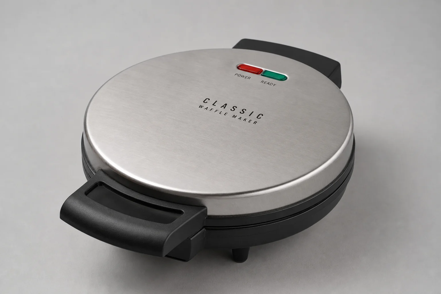 Five Cuisinart waffle makers arranged on concrete surface from budget to premium models