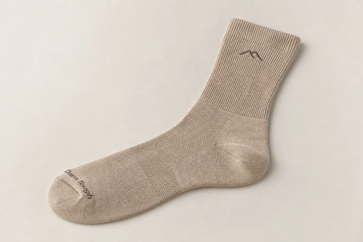 Collection of running socks in various colors and styles arranged on concrete surface