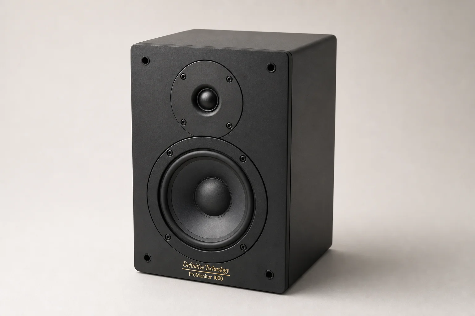 Six bookshelf speakers in varying sizes and finishes arranged on concrete surface