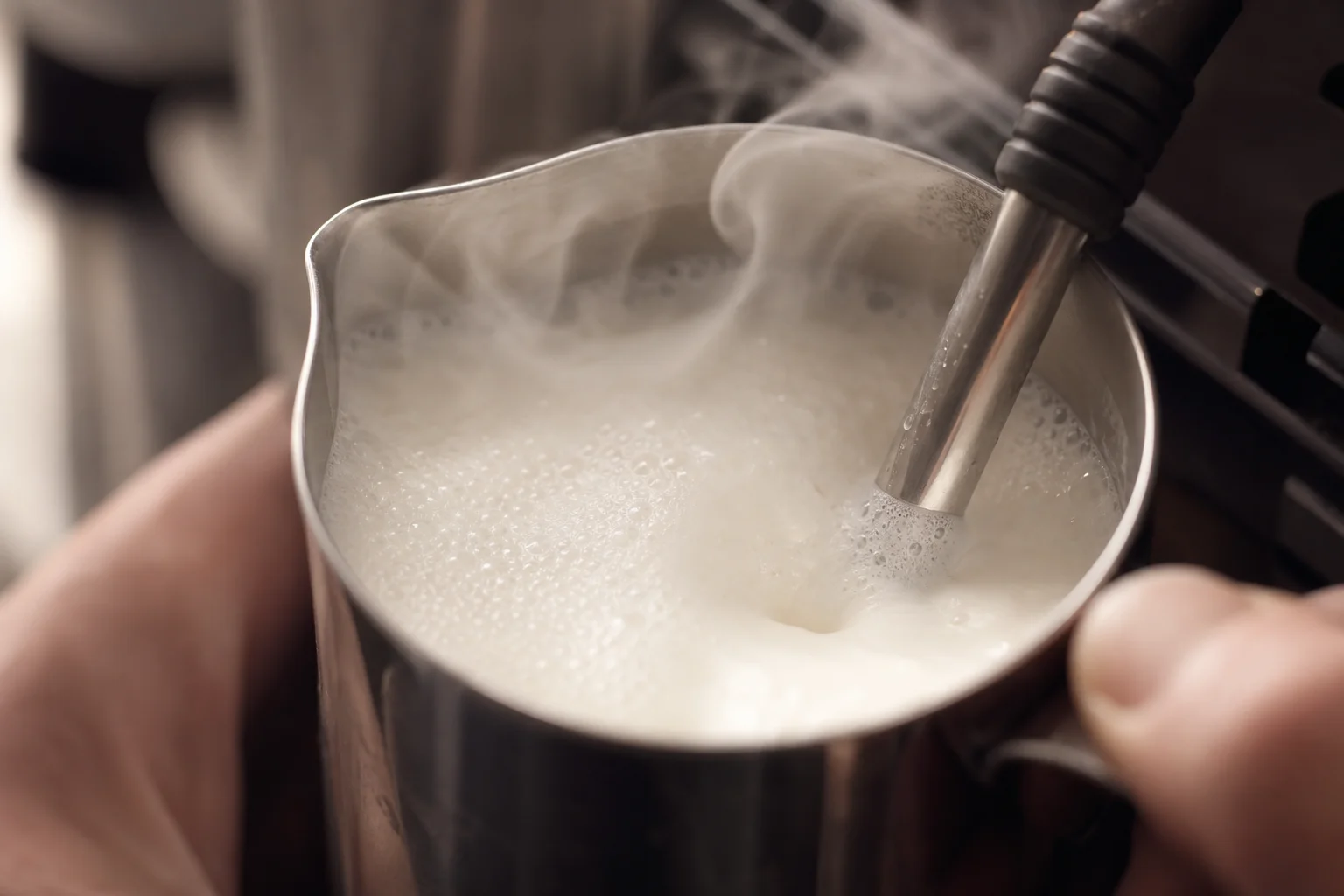 Steam wand producing dense milk foam in a metal pitcher