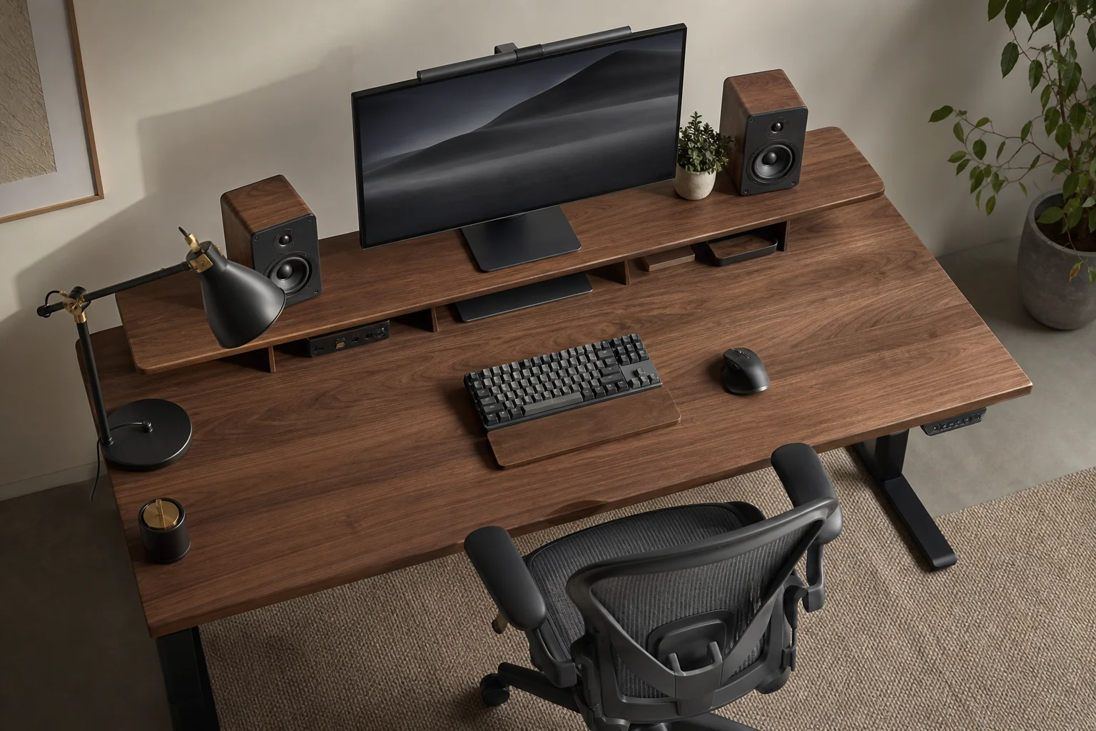 Complete desk setup with monitor, chair, speakers, and accessories on walnut desk
