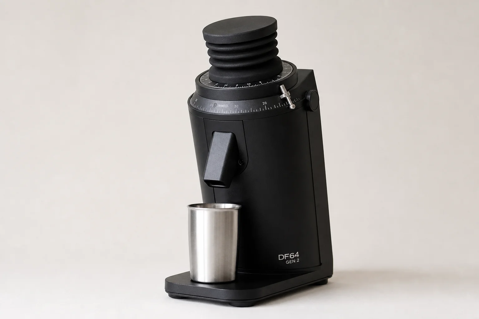 Seven espresso grinders of various sizes and styles arranged on concrete surface