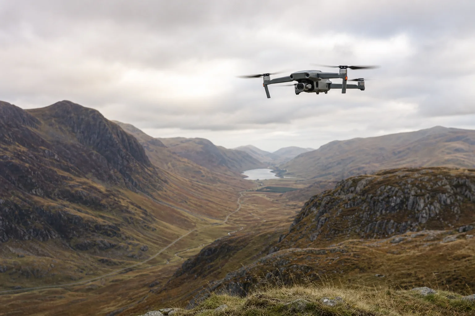 Drone flying over highland landscape with mountains and valleys