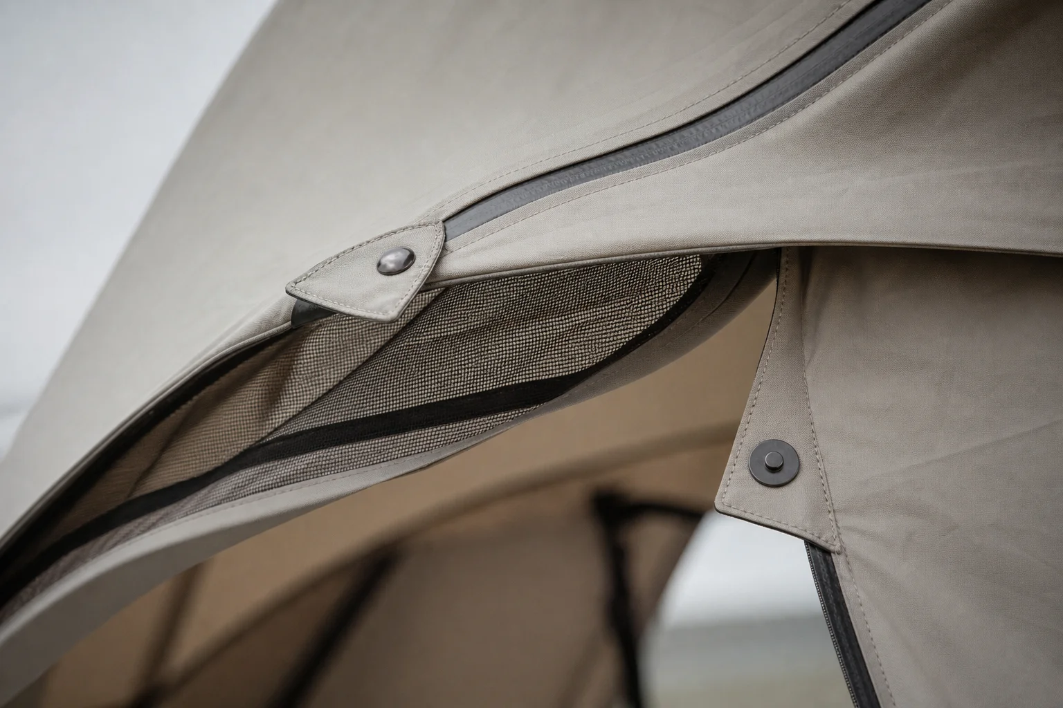 Close-up of tent door with magnetic toggle closure and ventilation vent