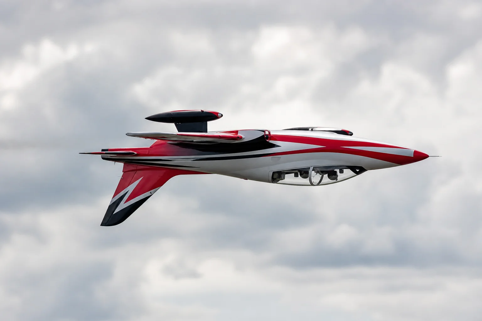 RC jet performing inverted flight maneuver in sky