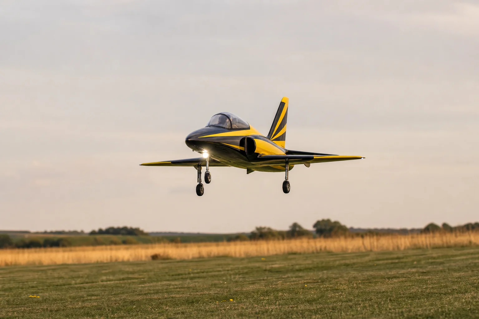 RC jet on final approach to grass runway with landing gear extended