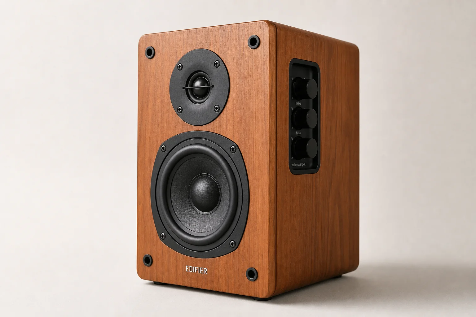 Five studio monitors arranged on concrete surface showing different sizes and designs