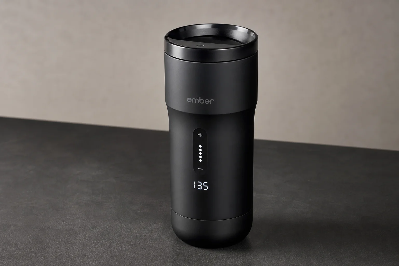 Five travel mugs arranged in ranking order on a concrete surface
