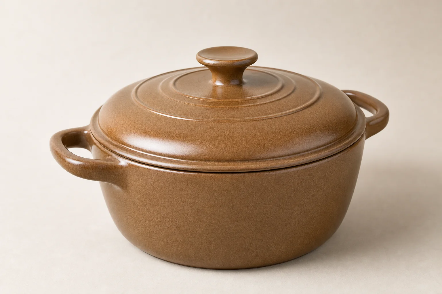 Three kitchen cookware vessels: cream Dutch oven, black Dutch oven with base, and slow cooker with glass lid