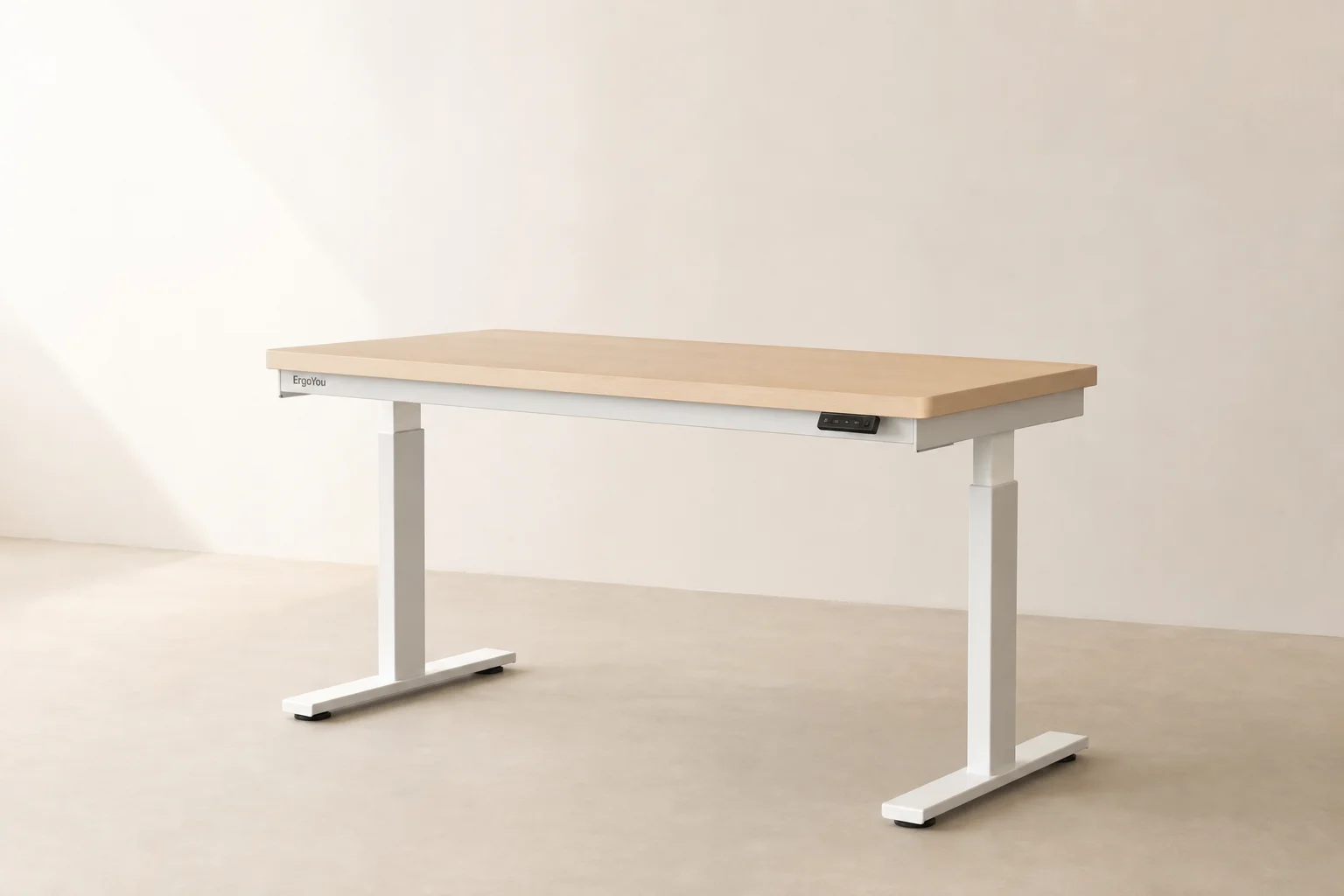Modern standing desk in raised position with laptop and monitor in bright home office