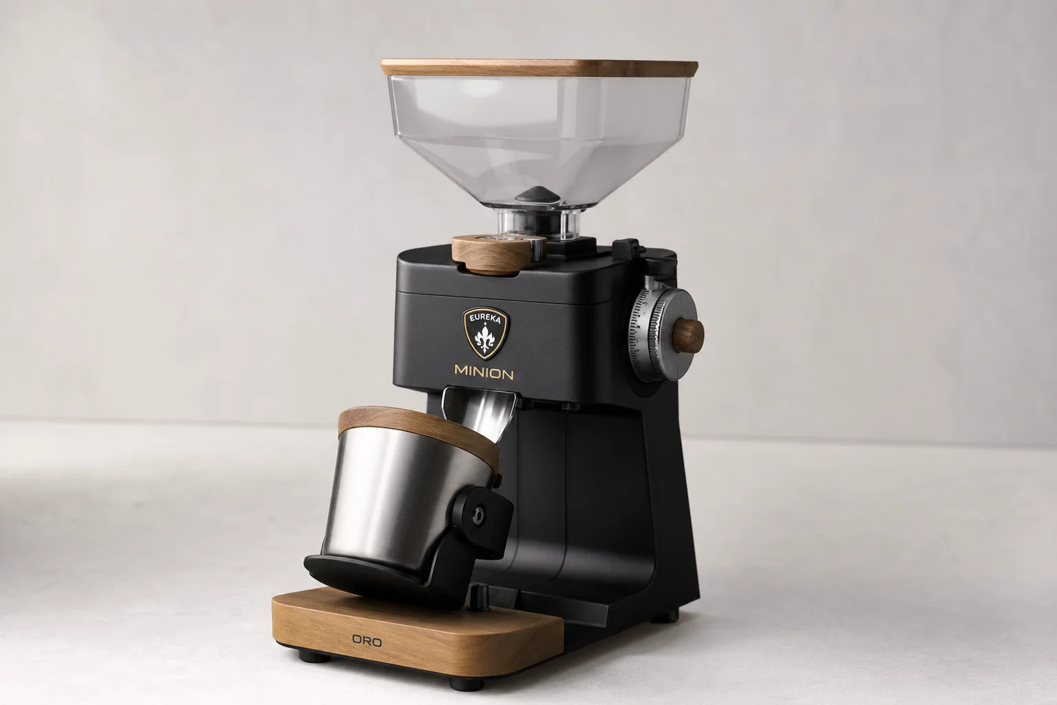 Seven espresso grinders of various sizes and styles arranged on concrete surface