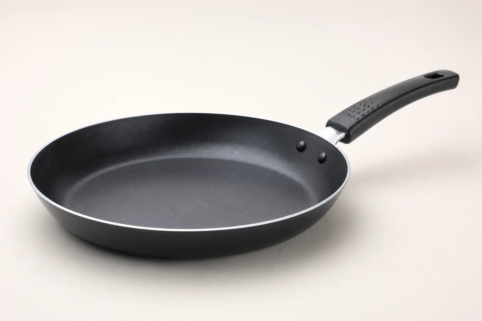 Collection of budget cookware including stainless steel, cast iron, non-stick, and enameled pans