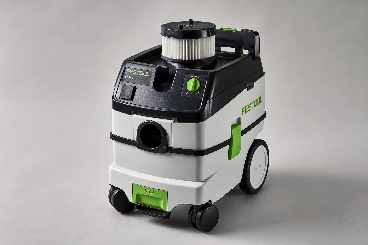 Festool and Rigid shop vacuums with bags and hoses on workshop floor