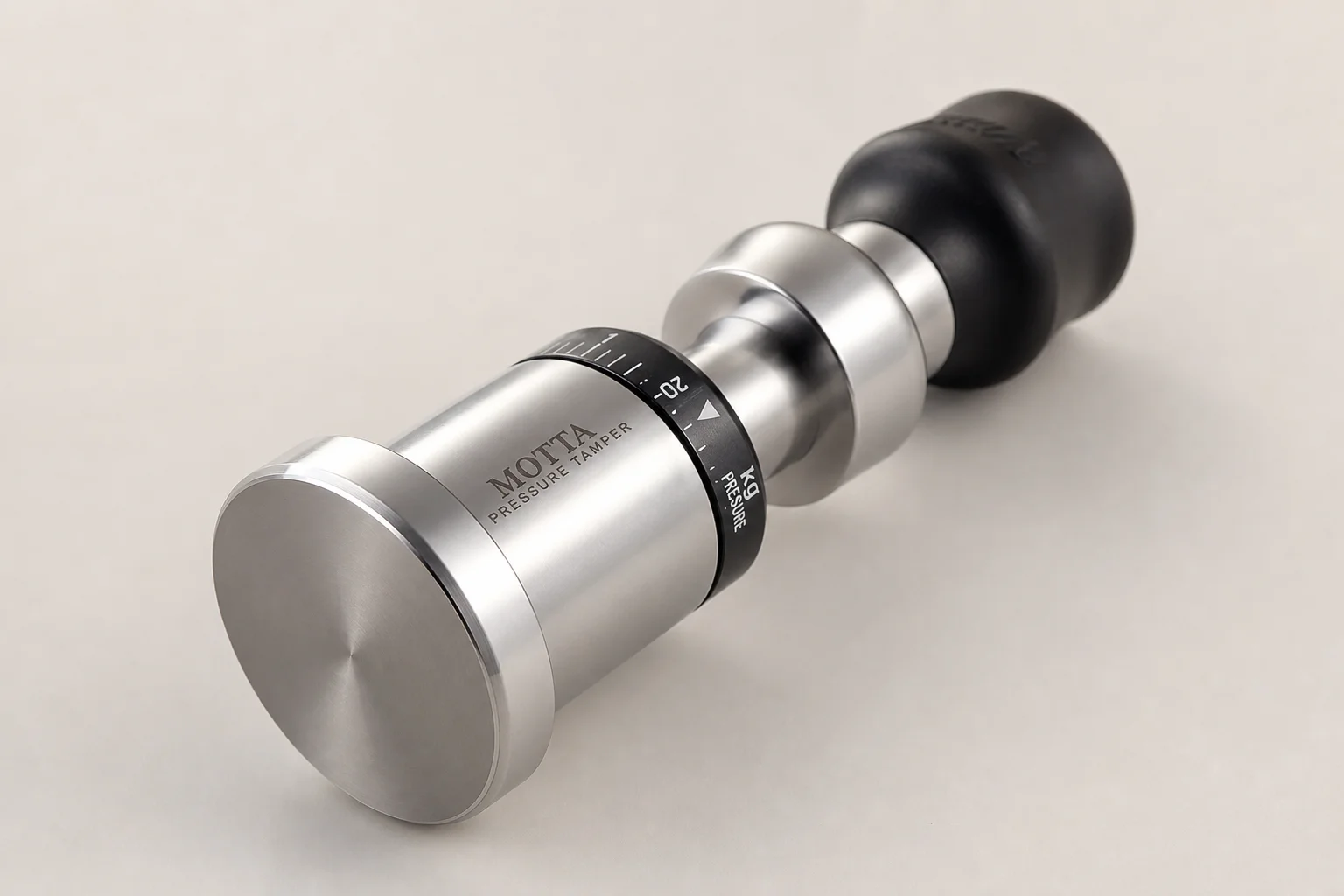 Espresso puck prep tools arranged on brushed steel surface