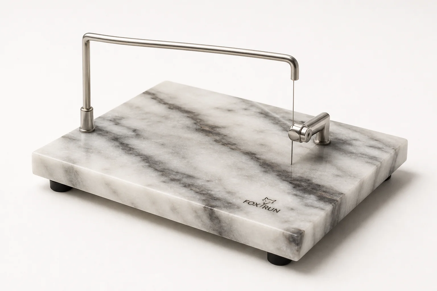 Five different cheese slicers arranged on a concrete surface