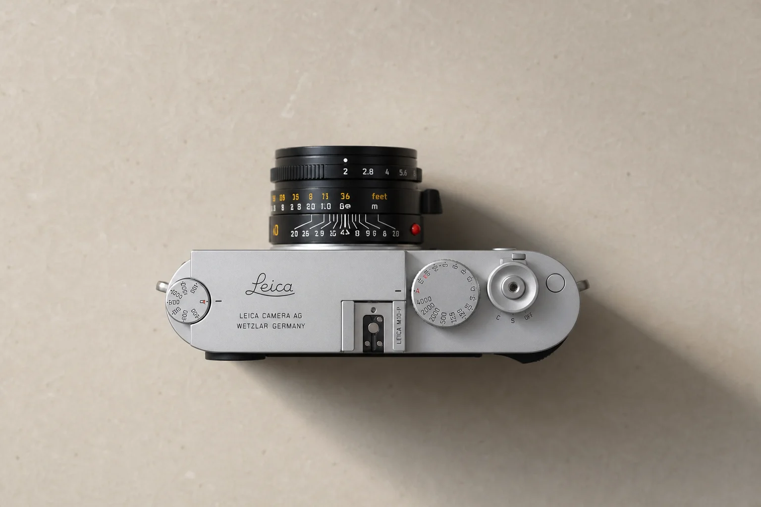 Overhead flat-lay of compact camera with optical viewfinder visible