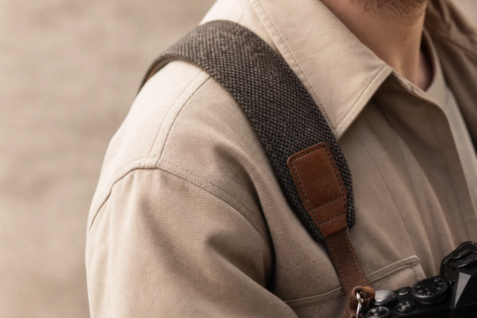 Close-up of camera strap detail showing leather and fabric texture