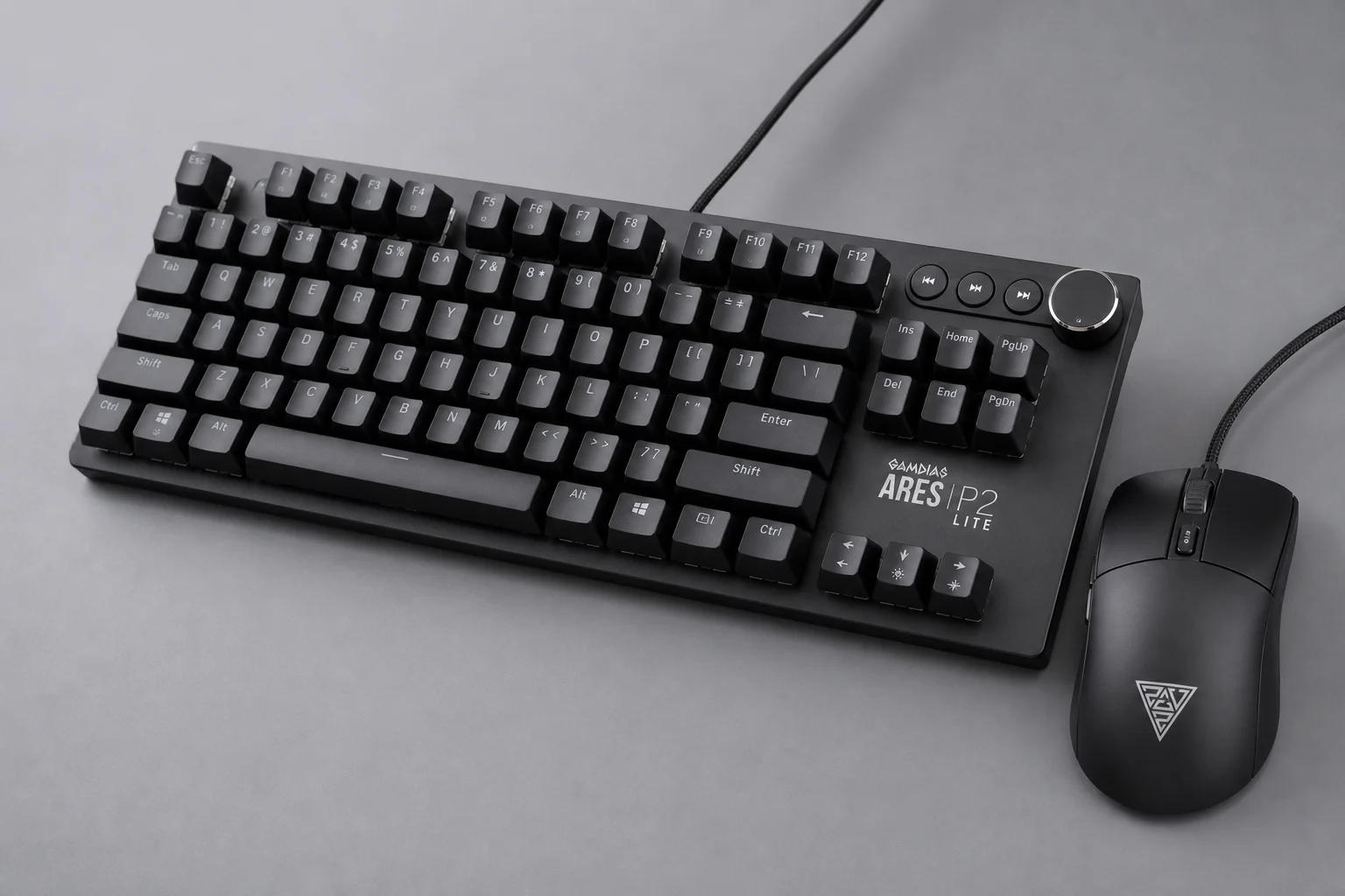 Eight gaming keyboard-mouse combos displayed on concrete surface showing various designs and colors