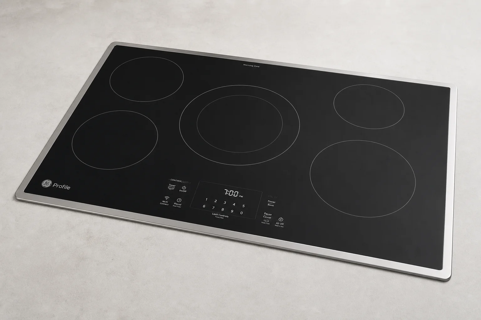 Five electric cooktops displayed in a line showing different designs and finishes