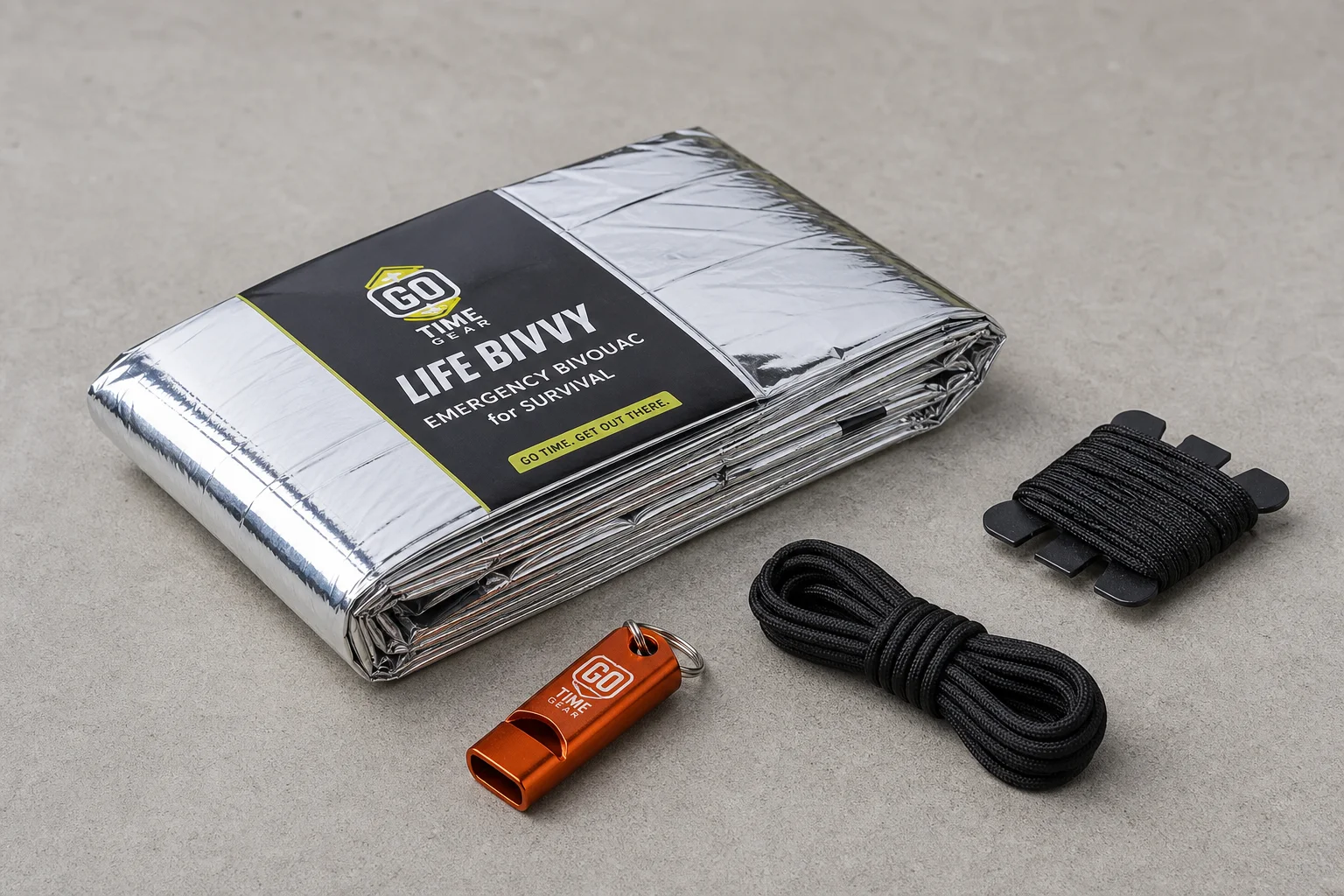 Five survival bivvy sacks in various colors arranged on concrete surface
