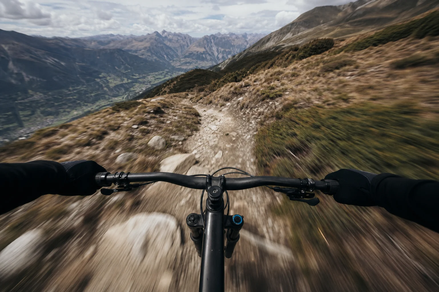 Ultra-wide POV shot from cyclist on mountain trail