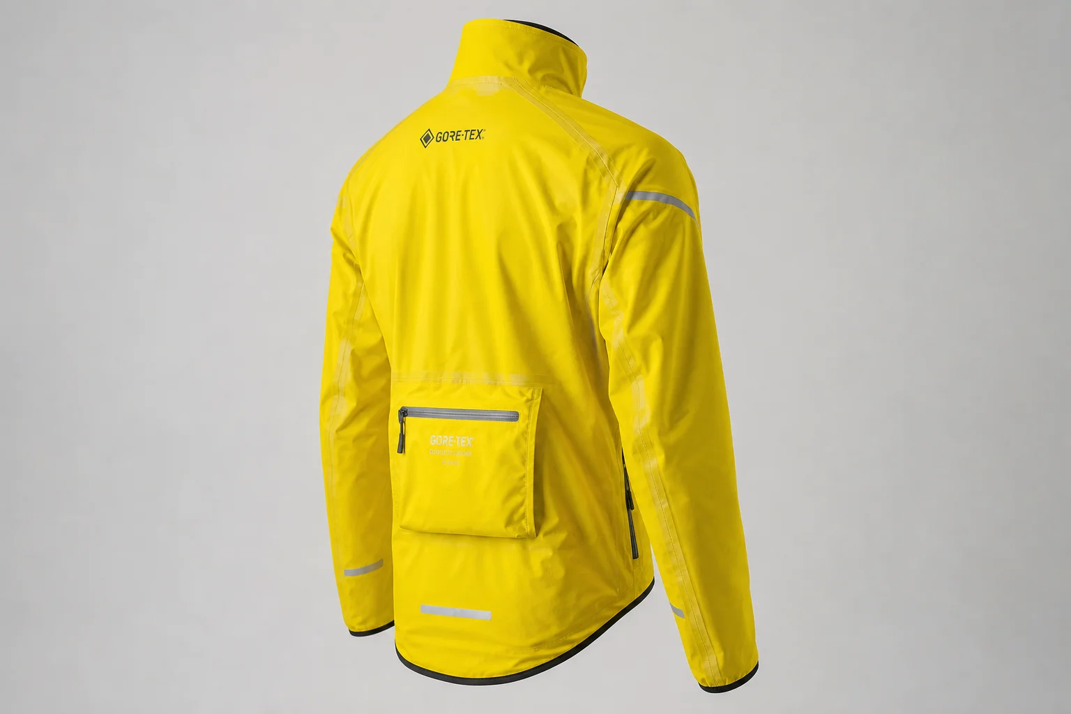 Five cycling rain jackets in various colors arranged on neutral backdrop