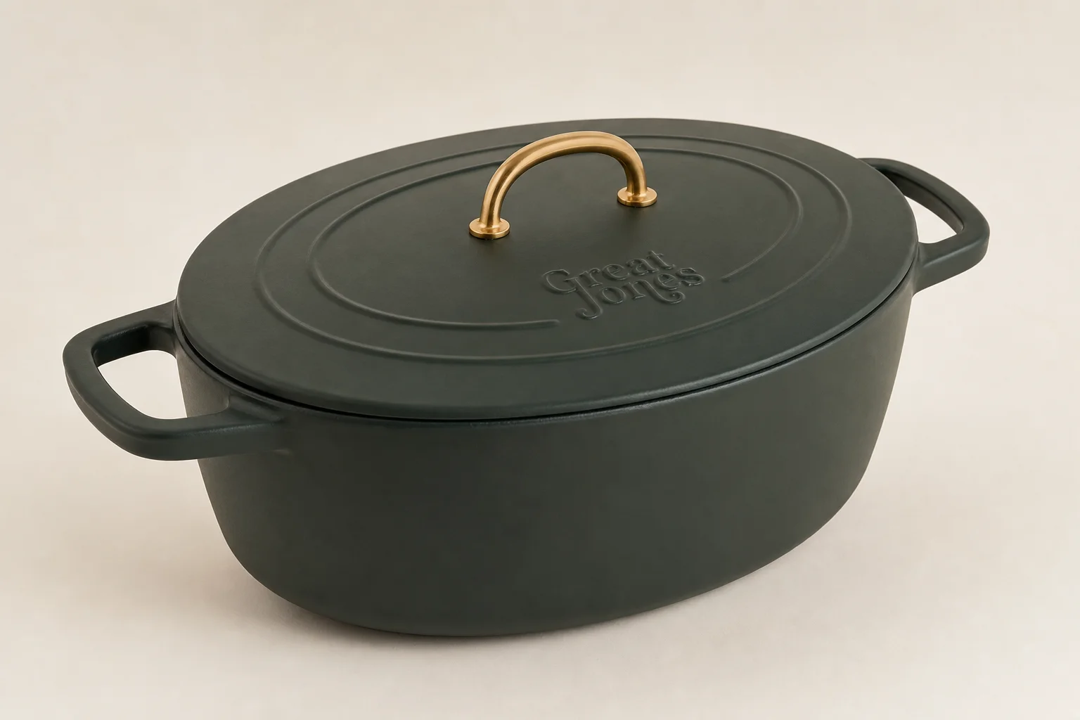 Collection of nine Dutch ovens in various colors and finishes arranged on neutral backdrop