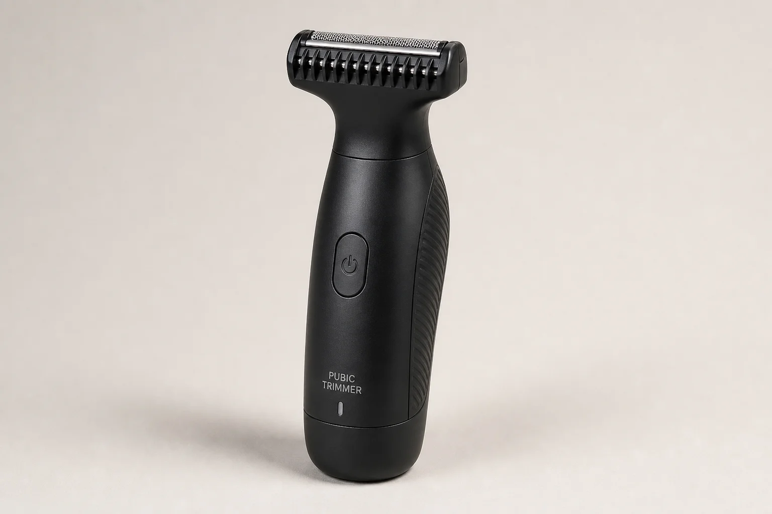 Six pubic hair trimmers arranged on grey surface showing various designs and attachments