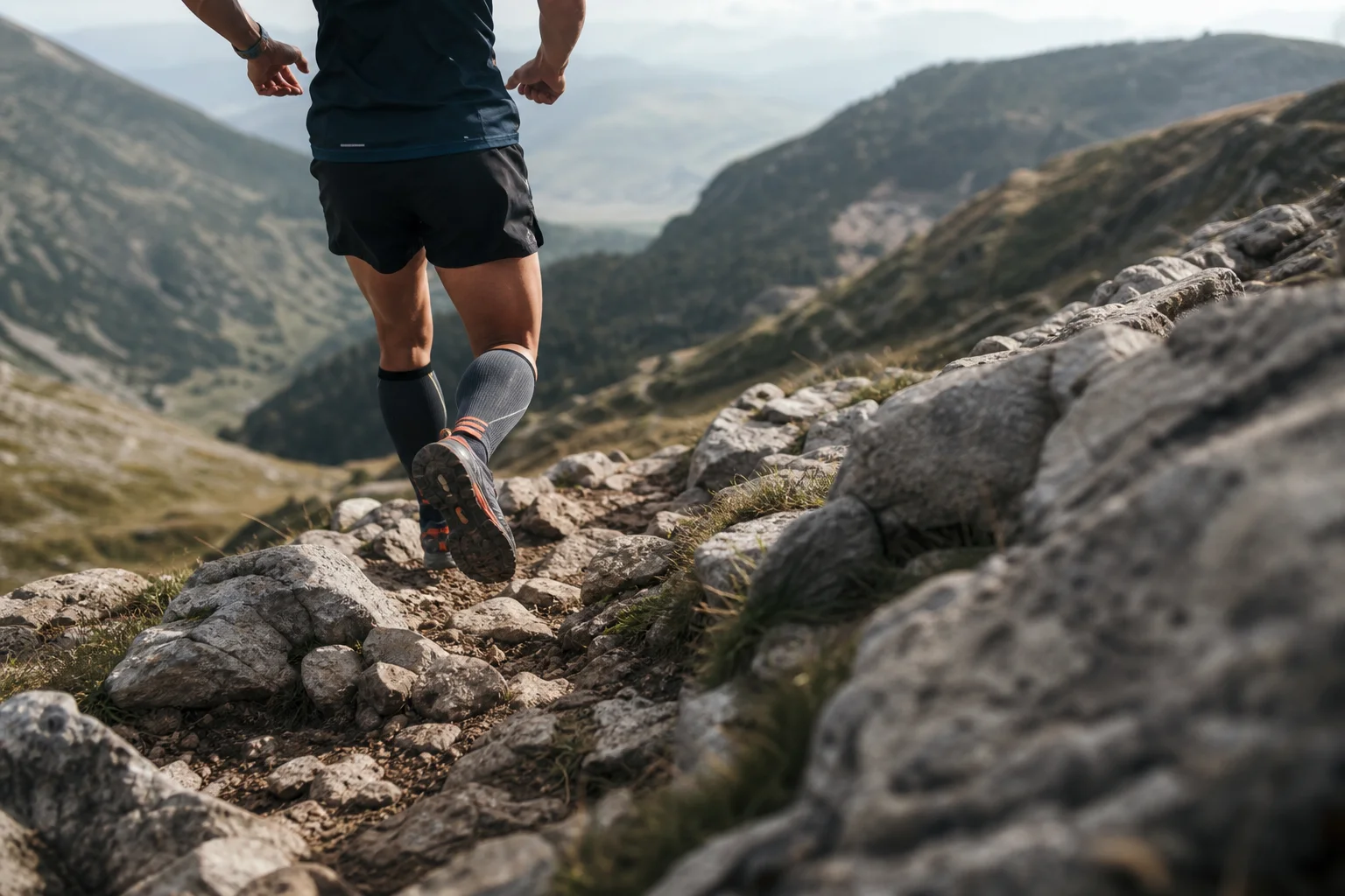 Trail runner navigating technical downhill terrain with rocky obstacles