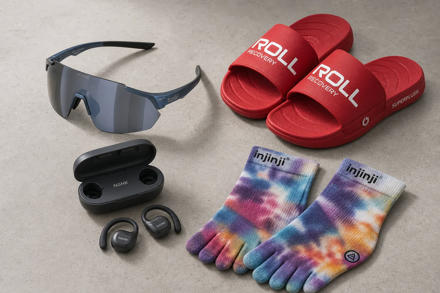 Running gear including sunglasses, earbuds, recovery slides, and colorful socks arranged on concrete