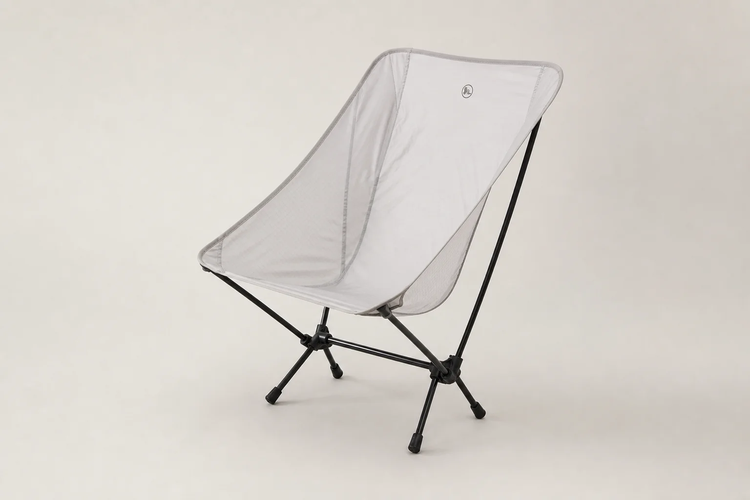 Four ultralight camping chairs arranged on neutral backdrop