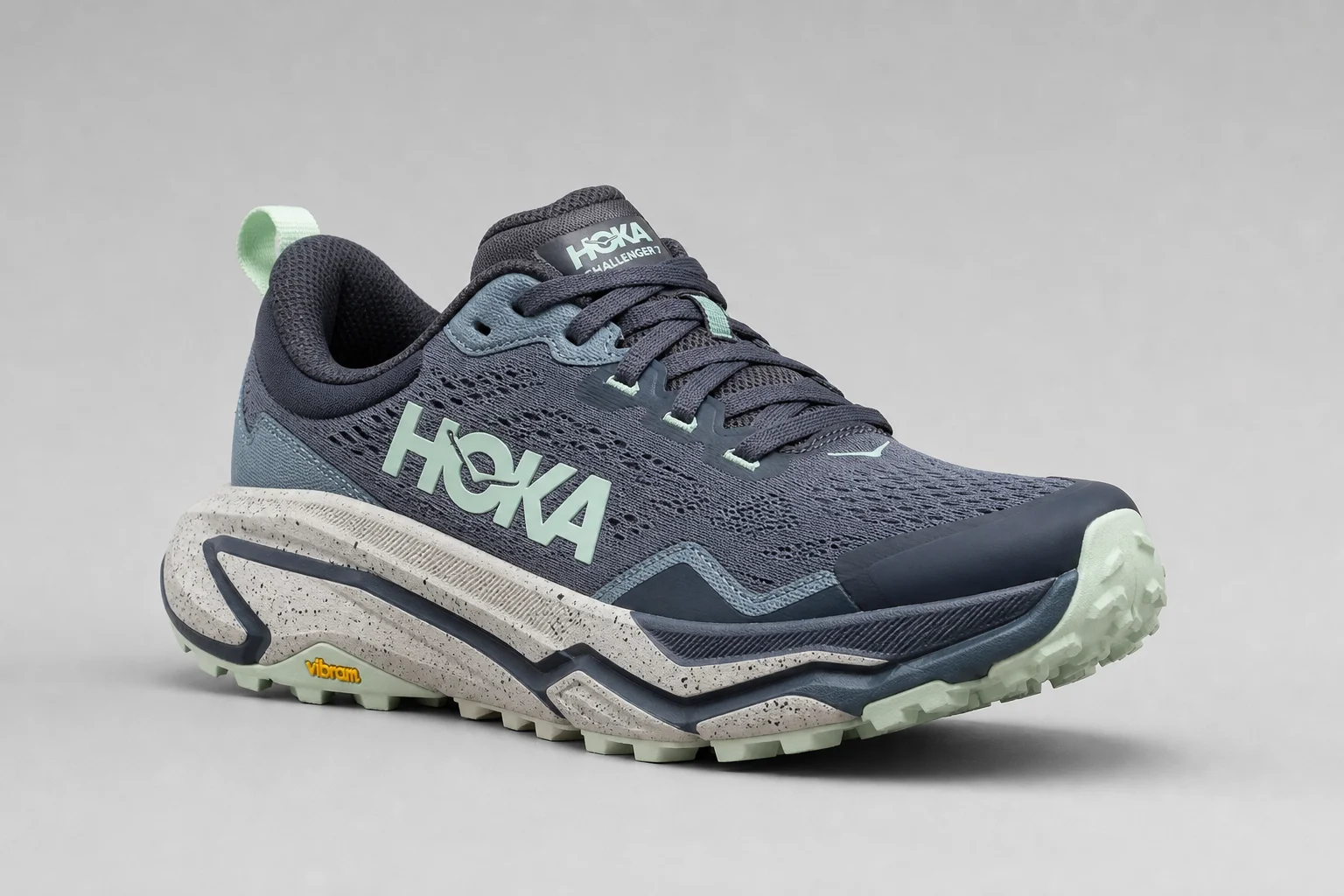 Three Hoka trail shoes displayed on concrete: Speedgoat 6, Challenger 7, and Stinson 7
