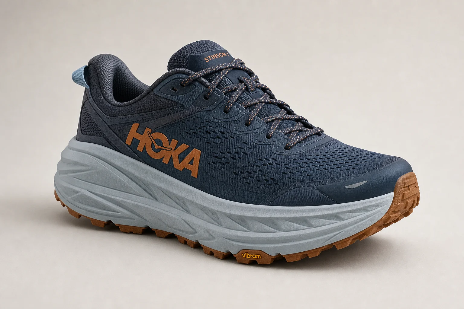 Five trail running shoes arranged on concrete surface showing different designs
